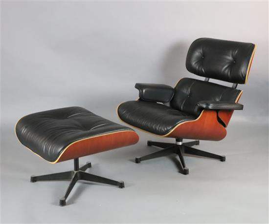 A Charles Eames cherrywood and black leather lounge chair with matching stool, made by Vitra, chair W.2ft 8in. D.2ft 8in. H.2ft 8.5in.